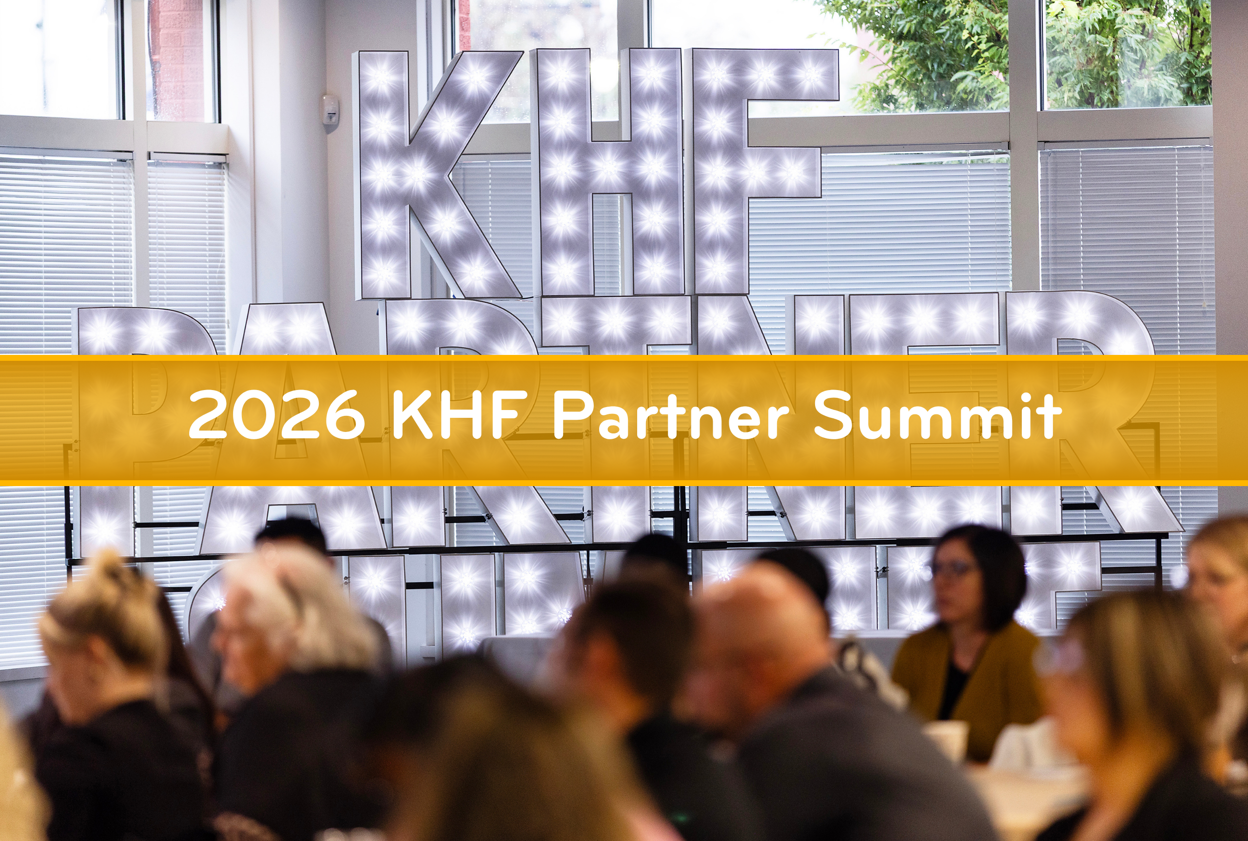 a room with a sign in the background that reads khf partners in lights